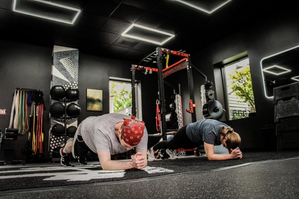 Coach leading a small group personal training session at Varsity House